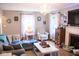 Cozy living room with hardwood floors, comfortable seating, a fireplace, and bright windows for a relaxed atmosphere at 643 Harlan St, Plainfield, IN 46168