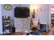 A comfortable living room featuring a TV, decorative cabinet, and a chair with a small dog crate at 643 Harlan St, Plainfield, IN 46168