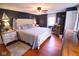 Comfortable bedroom with neutral colors, hardwood floors, and bright light at 643 Harlan St, Plainfield, IN 46168
