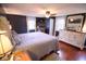 Comfortable bedroom with neutral colors, hardwood floors, and bright light at 643 Harlan St, Plainfield, IN 46168