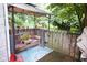 Outdoor patio with a cozy sitting area, including cushioned seating, a pergola, and decorative plants at 643 Harlan St, Plainfield, IN 46168