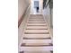 Carpeted stairway with wooden handrail leads to the upper levels of the home at 643 Harlan St, Plainfield, IN 46168