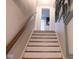 Carpeted stairway with wooden handrail leads to the upper levels of the home at 643 Harlan St, Plainfield, IN 46168