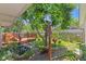 Serene backyard with lush greenery, a charming water feature, and a quaint wooden deck, creating a peaceful outdoor retreat at 649 Lawndale Dr, Plainfield, IN 46168