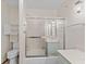 Clean bathroom with a tub-shower combo with sliding glass doors and built-in shelving at 649 Lawndale Dr, Plainfield, IN 46168