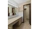 This primary bathroom features a large vanity with cabinets, sink, mirror, and stand up shower at 649 Lawndale Dr, Plainfield, IN 46168