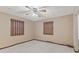 This bedroom features neutral carpet, natural light from two windows, and a ceiling fan with overhead lighting at 649 Lawndale Dr, Plainfield, IN 46168
