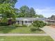 Charming brick ranch home featuring a manicured lawn and well-maintained landscaping at 649 Lawndale Dr, Plainfield, IN 46168