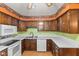 Functional kitchen with wood cabinetry, white appliances and countertops, offering a practical cooking space at 649 Lawndale Dr, Plainfield, IN 46168
