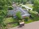 Backyard view of a brick home, lovely garden, mature trees, and a well-manicured lawn at 649 Lawndale Dr, Plainfield, IN 46168