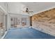 Enclosed sunroom with brick accent wall and sliding doors to outdoor patio at 649 Lawndale Dr, Plainfield, IN 46168
