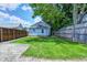 Large grassy backyard with a wooden fence and shade trees for privacy and enjoyment at 725 2Nd St, Shelbyville, IN 46176