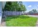 Lush green backyard with well-maintained lawn, mature trees, and wooden privacy fence at 725 2Nd St, Shelbyville, IN 46176