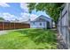 Spacious backyard features a well-maintained lawn and a wooden fence around the property at 725 2Nd St, Shelbyville, IN 46176