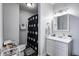 Bathroom featuring a white vanity, updated lighting, and a shower with a patterned curtain at 725 2Nd St, Shelbyville, IN 46176