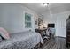 Bright bedroom with hardwood floors, a bed, desk area, and a view of the yard outside at 725 2Nd St, Shelbyville, IN 46176