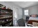 View of a charming bedroom with a bed, wood floors, a window and built-in shelves at 725 2Nd St, Shelbyville, IN 46176