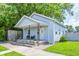 Charming blue home with a covered front porch, wrought iron posts, and tidy landscaping at 725 2Nd St, Shelbyville, IN 46176