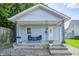 Charming front porch with seating area, potted plants, and curb appeal at 725 2Nd St, Shelbyville, IN 46176