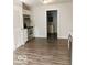 Open concept kitchen with stainless steel appliances, natural light, and access to a bathroom at 725 2Nd St, Shelbyville, IN 46176