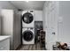 Convenient laundry area with stacked washer and dryer set, shelving, and storage at 725 2Nd St, Shelbyville, IN 46176