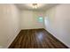 Clean bedroom with wood flooring, neutral walls, and a bright window, offering a peaceful space to relax at 7301 E Wiser Ave, Camby, IN 46113
