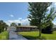 Charming one-story home with brick facade, green shutters, manicured lawn and detached garage at 7301 E Wiser Ave, Camby, IN 46113