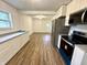 Well-lit kitchen featuring stainless steel appliances, new cabinets, and updated flooring, with an open layout to the living area at 7301 E Wiser Ave, Camby, IN 46113
