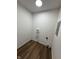 Simple utility room with vinyl flooring, utility connections, and white walls, perfect for laundry and storage at 7301 E Wiser Ave, Camby, IN 46113