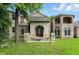 Brick and stone entrance to the house featuring a unique arched double door design at 7843 E Triple Crown Ln, Camby, IN 46113