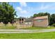 Home exterior featuring a classic brick design, expansive driveway, and lush greenery at 7843 E Triple Crown Ln, Camby, IN 46113
