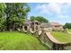 Stunning brick home featuring a curved brick retaining wall and beautiful landscaping at 7843 E Triple Crown Ln, Camby, IN 46113