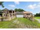 Home exterior with a long driveway and a well-maintained lawn at 7843 E Triple Crown Ln, Camby, IN 46113