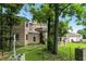 Large brick home with expansive yard and stone accents, surrounded by mature trees at 7843 E Triple Crown Ln, Camby, IN 46113