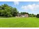 Scenic view of a large home, driveway, and extensive lawn, surrounded by mature trees at 7843 E Triple Crown Ln, Camby, IN 46113