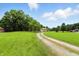 Extensive lot with a long gravel driveway leading to a grand home and garage at 7843 E Triple Crown Ln, Camby, IN 46113