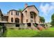 View of the back of a large pink brick home, with unique architectural features at 7843 E Triple Crown Ln, Camby, IN 46113