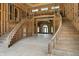 Unfinished grand foyer showcasing a dual staircase, large windows, and potential design at 7843 E Triple Crown Ln, Camby, IN 46113