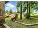 Landscaped front yard with brick features, trees, and view of the home at 7843 E Triple Crown Ln, Camby, IN 46113