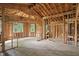 Spacious unfinished interior showcasing the wood framing, archways, and natural light from windows at 7843 E Triple Crown Ln, Camby, IN 46113