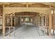 Unfinished interior showcasing the wood framing and window placement at 7843 E Triple Crown Ln, Camby, IN 46113