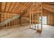 Spacious room under construction, featuring wood framing, plywood subfloor, and an open layout with natural light from windows at 7843 E Triple Crown Ln, Camby, IN 46113
