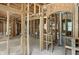 Interior shot of a house under construction, featuring wooden framework, arched doorways, and window placements at 7843 E Triple Crown Ln, Camby, IN 46113