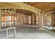 Spacious interior view displaying the wooden framework of a home during construction, showcasing open room layouts at 7843 E Triple Crown Ln, Camby, IN 46113