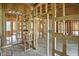 Interior view of a home under construction, showcasing the wooden framework and arched doorway at 7843 E Triple Crown Ln, Camby, IN 46113