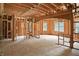 Interior view of new construction, highlighting the wooden framework, arched doorway, and natural light from windows at 7843 E Triple Crown Ln, Camby, IN 46113