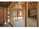 A look through the unfinished interior featuring wood studs, wiring, and natural light coming through the windows at 7843 E Triple Crown Ln, Camby, IN 46113