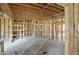 Spacious unfinished living room featuring rough framing and an open floor plan at 7843 E Triple Crown Ln, Camby, IN 46113