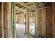 Unfinished living room featuring rough framing, spacious layout and abundant natural light at 7843 E Triple Crown Ln, Camby, IN 46113