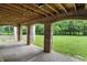 Outdoor patio featuring brick columns, a wooden ceiling, and a view of a lush green yard at 7843 E Triple Crown Ln, Camby, IN 46113